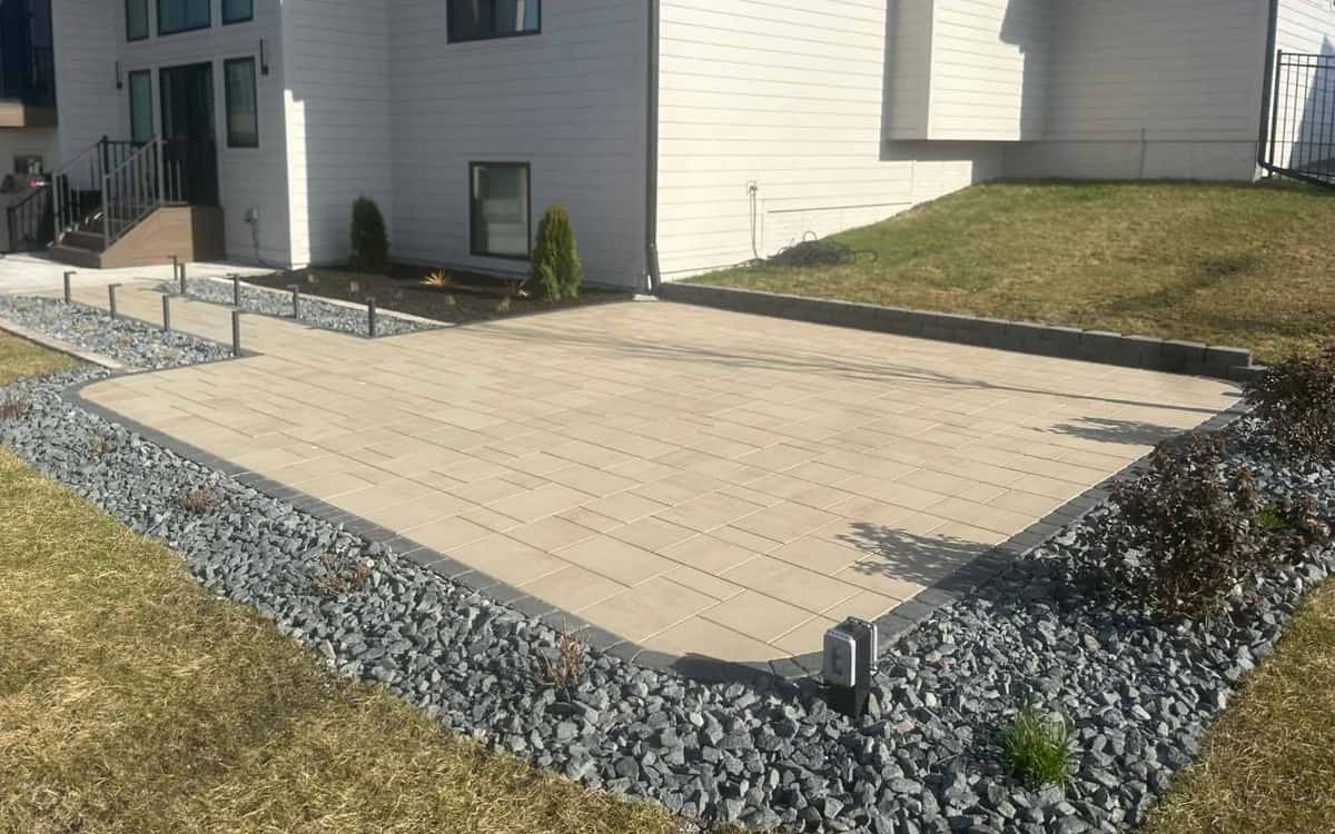 Paver patio with gravel border and landscape lighting